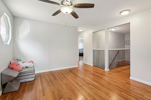 unfurnished room with ceiling fan and light wood-type flooring