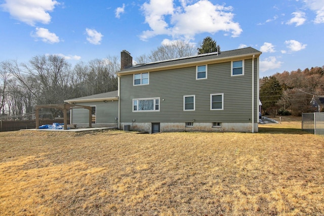 rear view of house with a yard and a patio