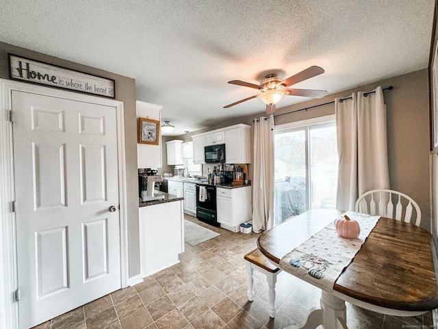 dining area featuring a textured ceiling and ceiling fan