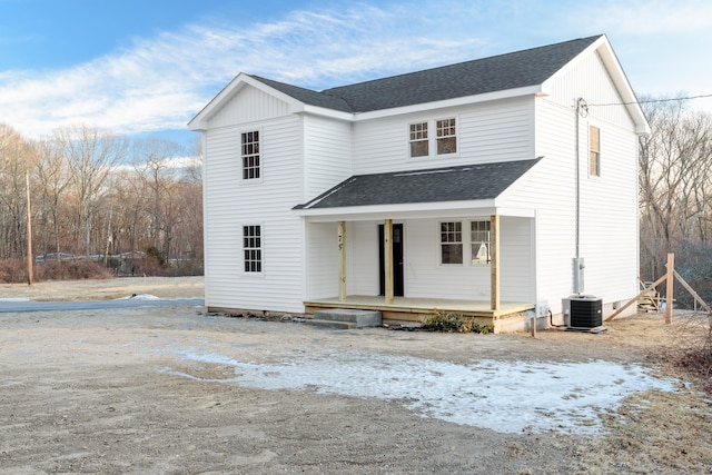 view of front property featuring cooling unit and a porch