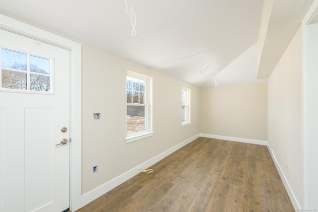 interior space featuring hardwood / wood-style flooring and lofted ceiling