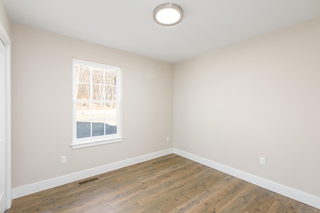 unfurnished room featuring dark wood-type flooring