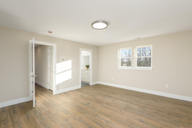 empty room with dark hardwood / wood-style floors