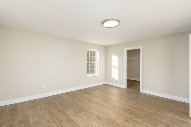 empty room with hardwood / wood-style floors