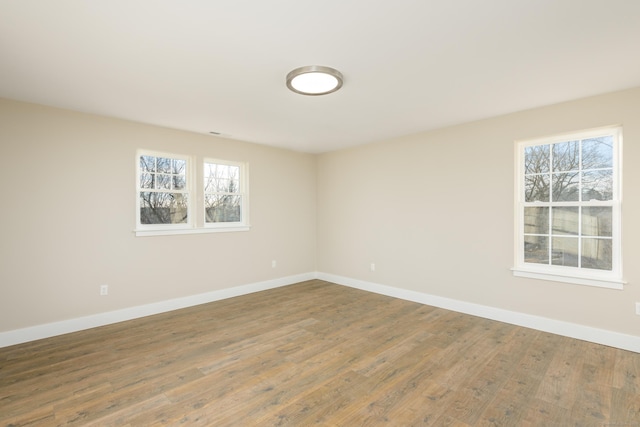 spare room with wood-type flooring