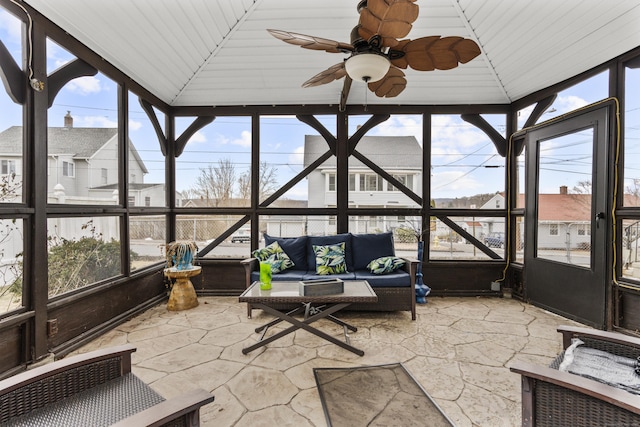 unfurnished sunroom featuring vaulted ceiling and ceiling fan