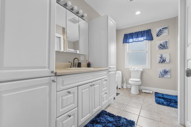 bathroom with toilet, tile patterned floors, and vanity