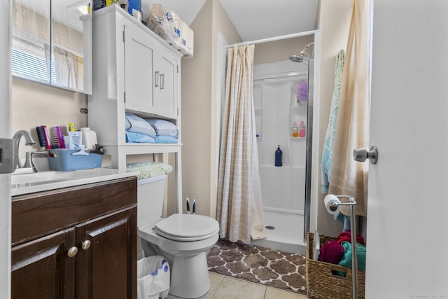 bathroom with toilet, walk in shower, vanity, and tile patterned flooring