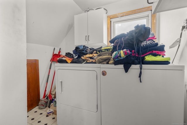 washroom with cabinets and washing machine and dryer