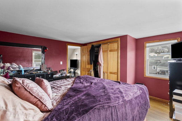 bedroom featuring a closet and light hardwood / wood-style floors