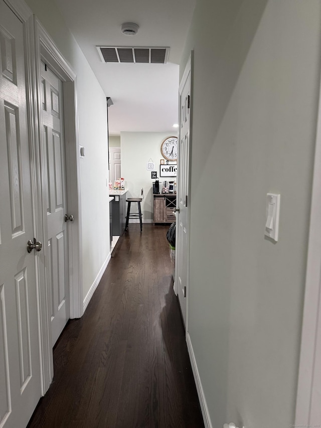 hallway with dark hardwood / wood-style flooring