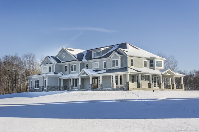 view of front of house with covered porch and stone siding