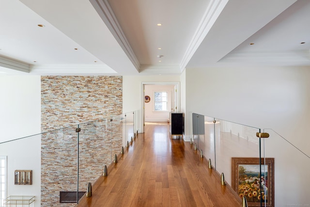 hall featuring crown molding, recessed lighting, wood finished floors, and a raised ceiling