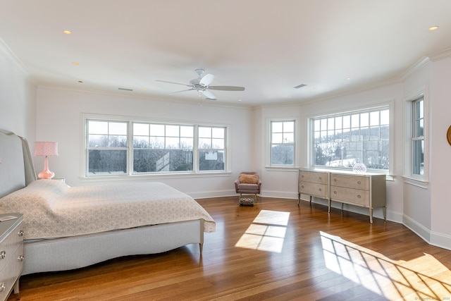 bedroom featuring crown molding, baseboards, ceiling fan, and wood finished floors