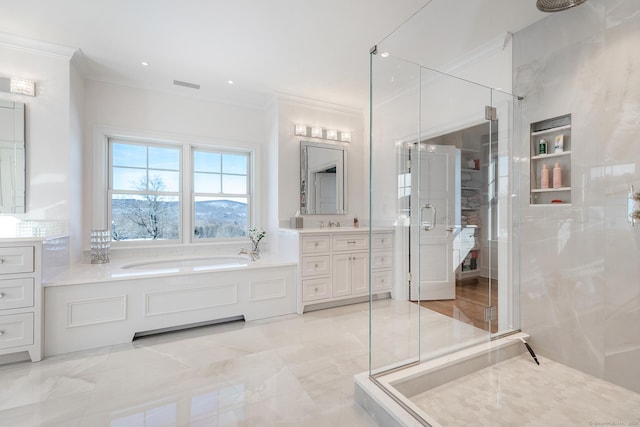 bathroom with crown molding, a garden tub, a stall shower, and vanity