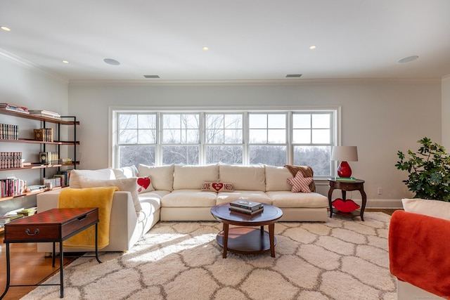 living area featuring crown molding, a healthy amount of sunlight, and visible vents