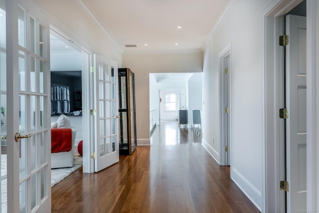 hall with crown molding, dark wood finished floors, french doors, baseboards, and visible vents