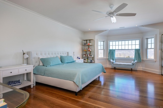 bedroom featuring baseboards, ornamental molding, and wood finished floors
