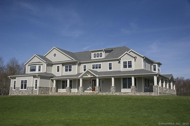 view of front facade with covered porch, stone siding, and a front lawn