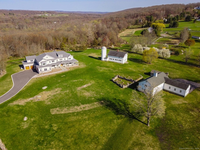 aerial view featuring a wooded view