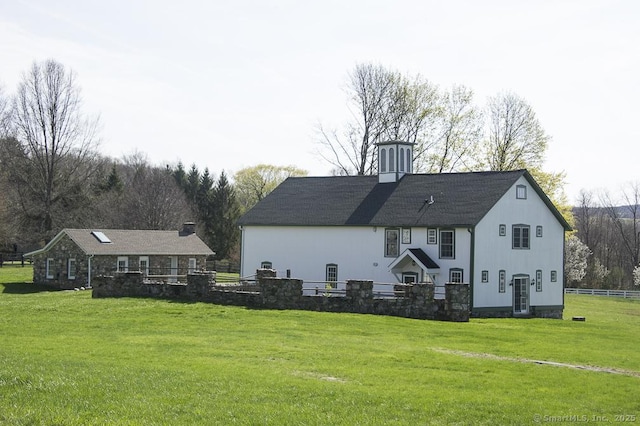 back of property with a yard and a chimney