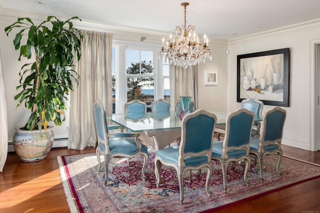 dining room featuring a chandelier, dark wood-type flooring, ornamental molding, and a baseboard radiator