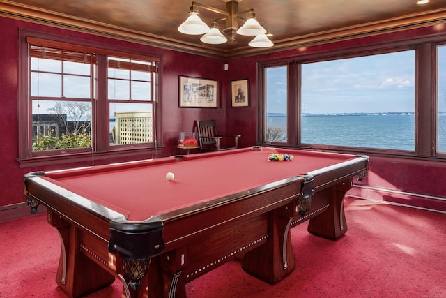 recreation room with carpet floors, billiards, ornamental molding, and a water view