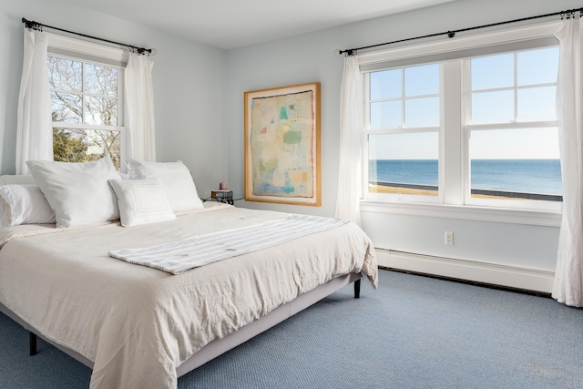 bedroom with a water view, carpet floors, and a baseboard radiator