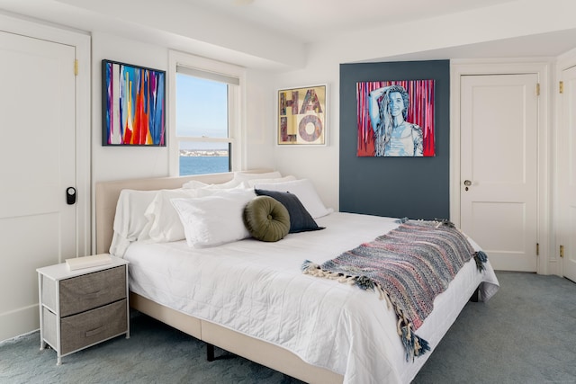 carpeted bedroom with a water view