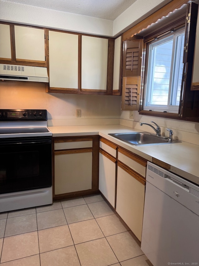 kitchen with white dishwasher, sink, light tile patterned flooring, electric range oven, and range hood