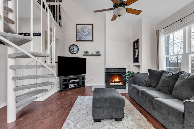 living room featuring vaulted ceiling, ceiling fan, and dark hardwood / wood-style floors