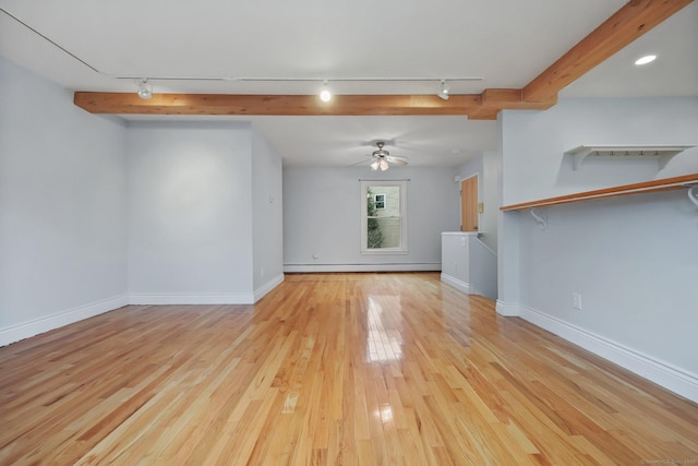 unfurnished living room with ceiling fan, rail lighting, light hardwood / wood-style flooring, and a baseboard radiator