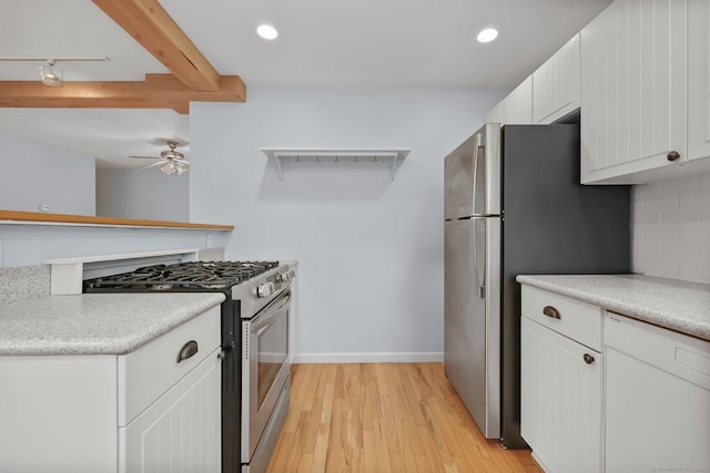 kitchen featuring white cabinets, appliances with stainless steel finishes, track lighting, light hardwood / wood-style floors, and ceiling fan