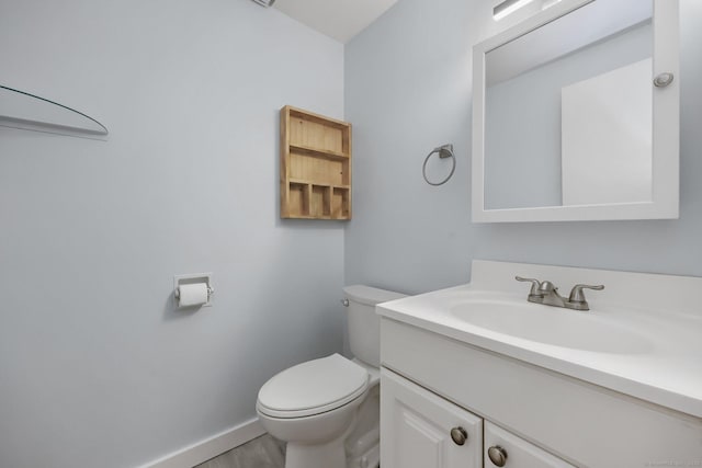 bathroom featuring toilet and vanity