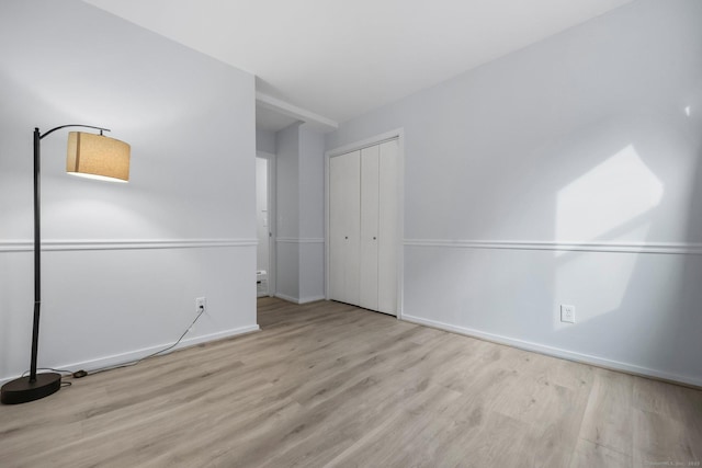 empty room with light hardwood / wood-style flooring