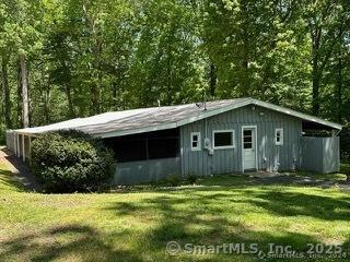 view of outbuilding featuring a yard