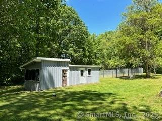 view of outbuilding with a lawn