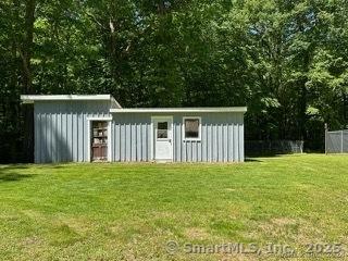 view of outbuilding with a yard