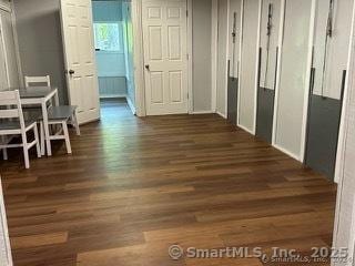 hall with dark wood-type flooring