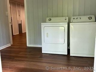 clothes washing area featuring dark wood-type flooring and washer and dryer