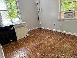 interior space featuring cooling unit and dark parquet floors