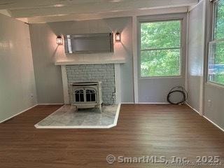 unfurnished living room with dark wood-type flooring and plenty of natural light