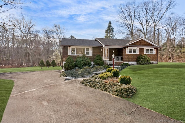 single story home with a porch and a front yard