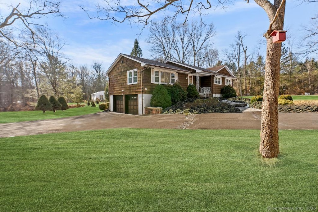 view of front of home featuring a garage and a front yard