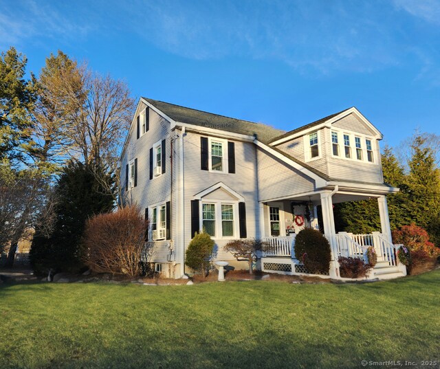 view of front of house with a front yard and a porch