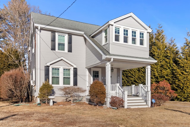 view of front of property with a porch and a front yard