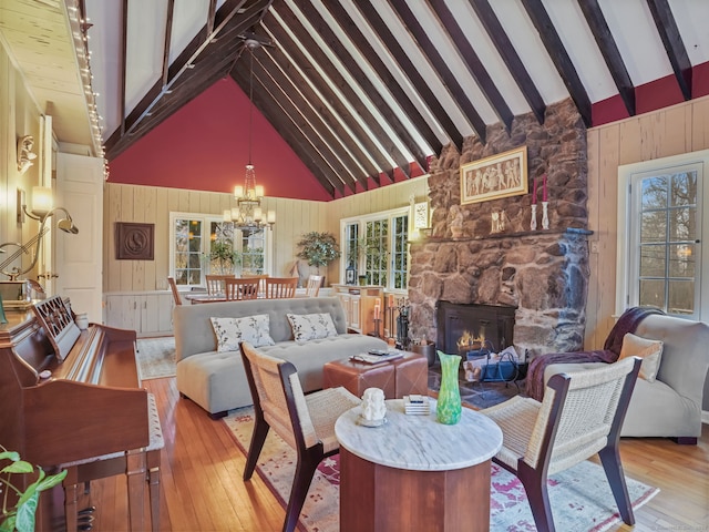 interior space with high vaulted ceiling, light hardwood / wood-style floors, and beamed ceiling