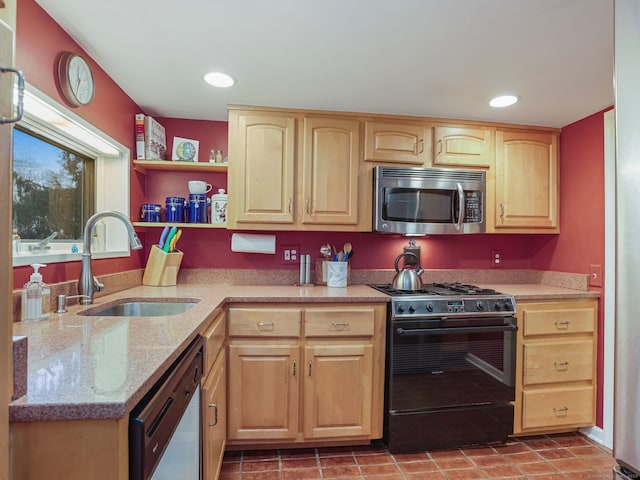 kitchen with stainless steel appliances, sink, light brown cabinets, and light stone counters