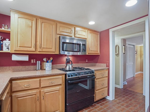 kitchen with light brown cabinets and appliances with stainless steel finishes