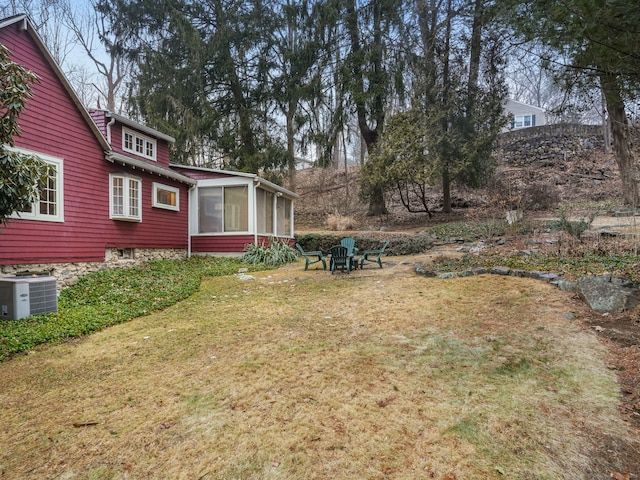 view of yard featuring cooling unit and a sunroom